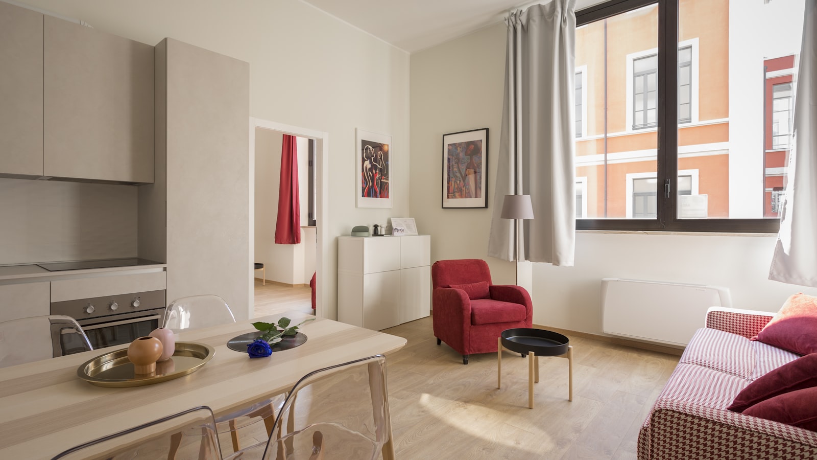 Modern apartment living space with table and seating.