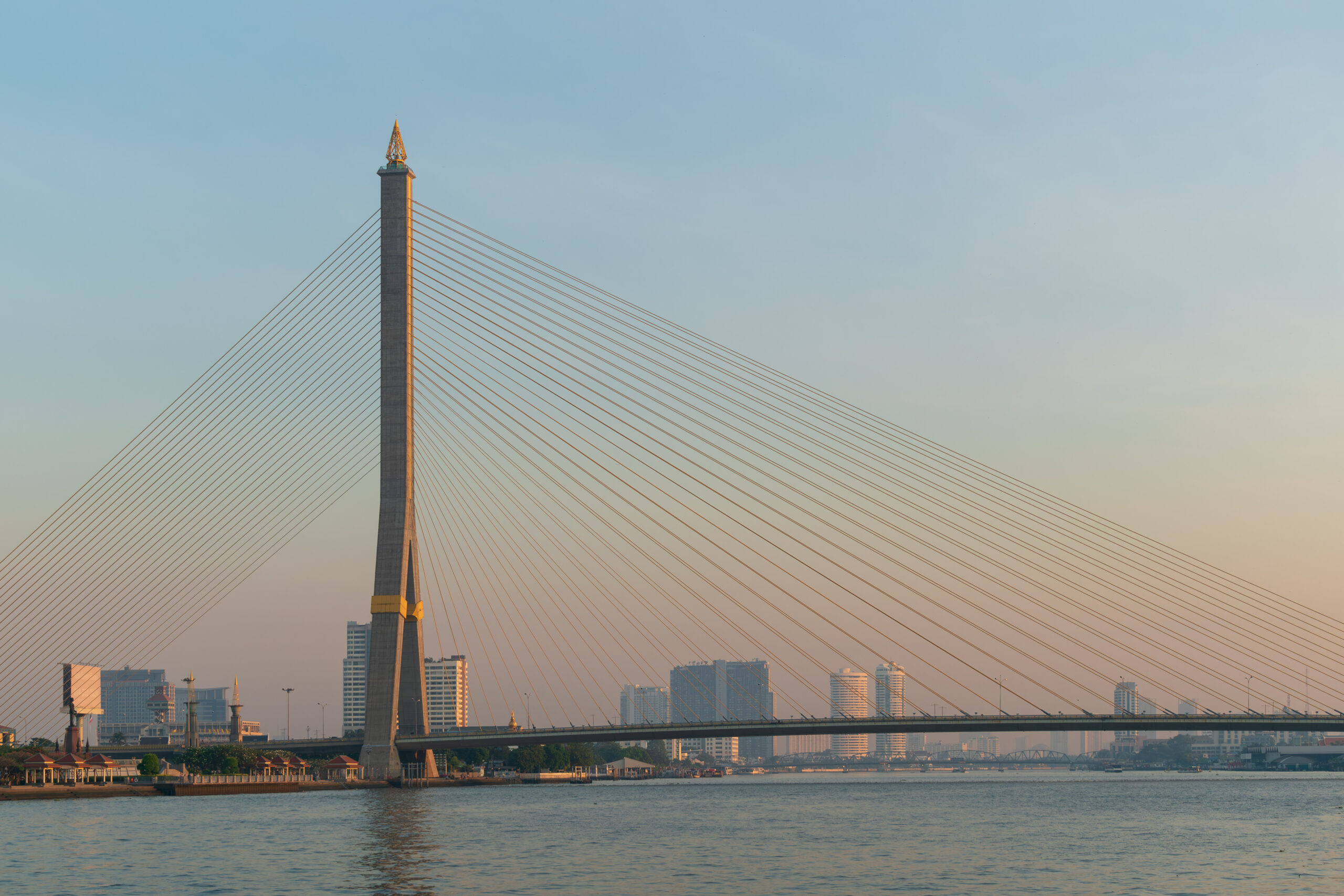 Rama VIII Bridge in Bangkok at sunrise over the Chao Phraya River.