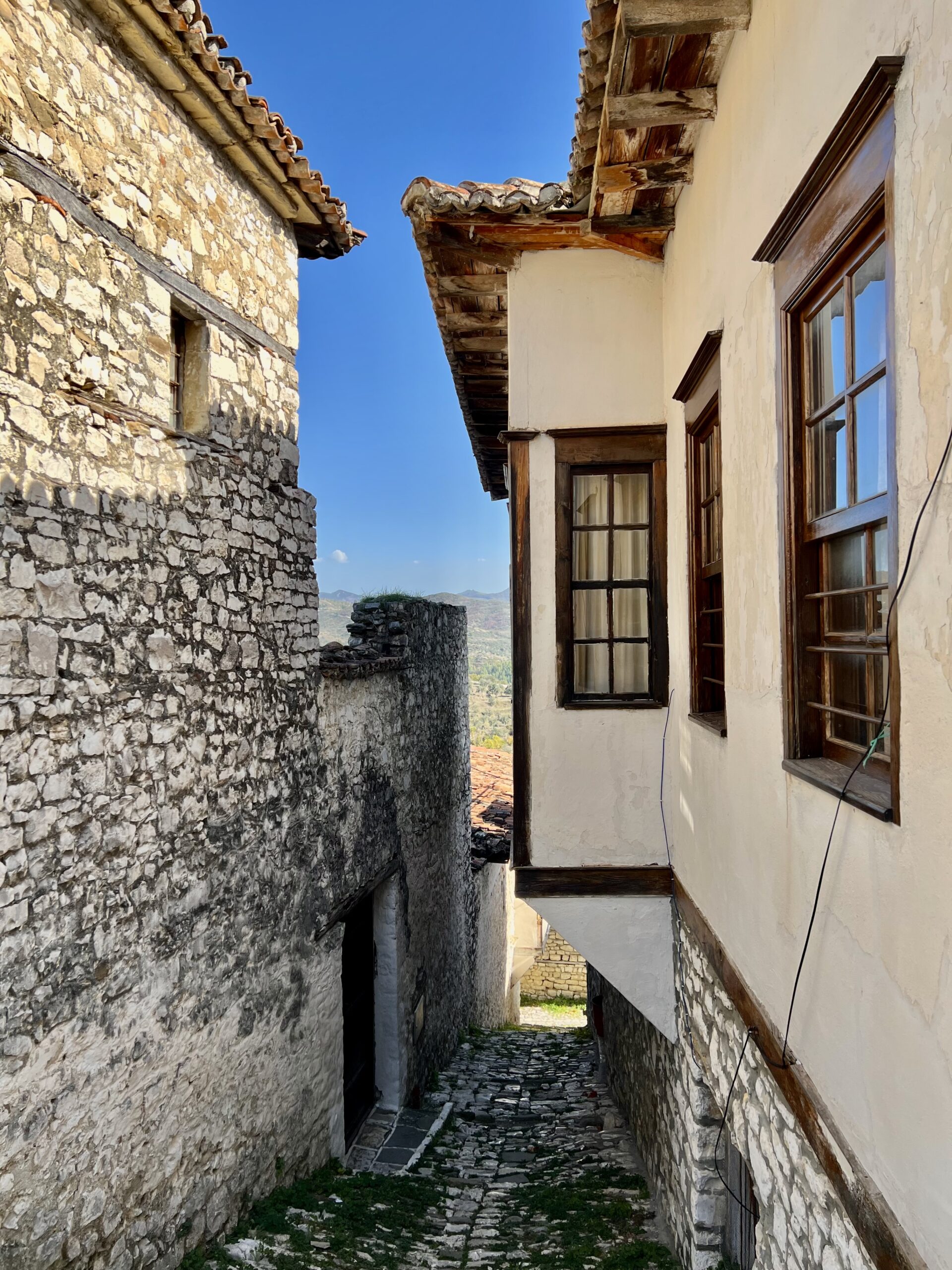 Stone alley between historic houses in Berat, Albania.