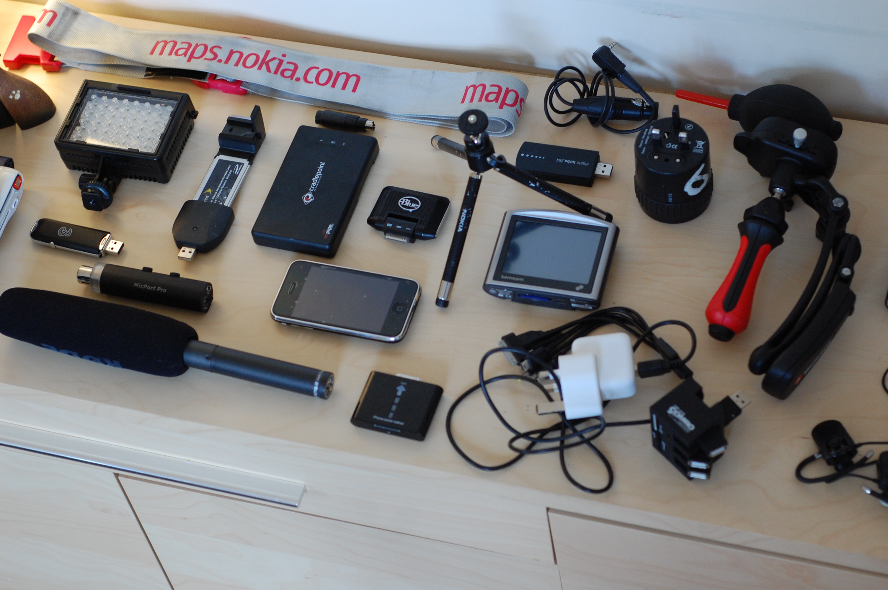 Compact tech pouch and travel basics arranged to keep a longer stay abroad low-friction.