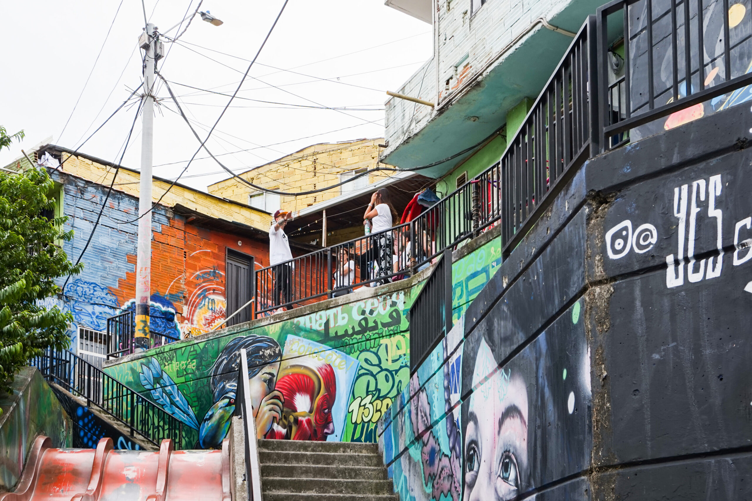Colorful mural-covered street scene in Medellín’s Comuna 13 area.