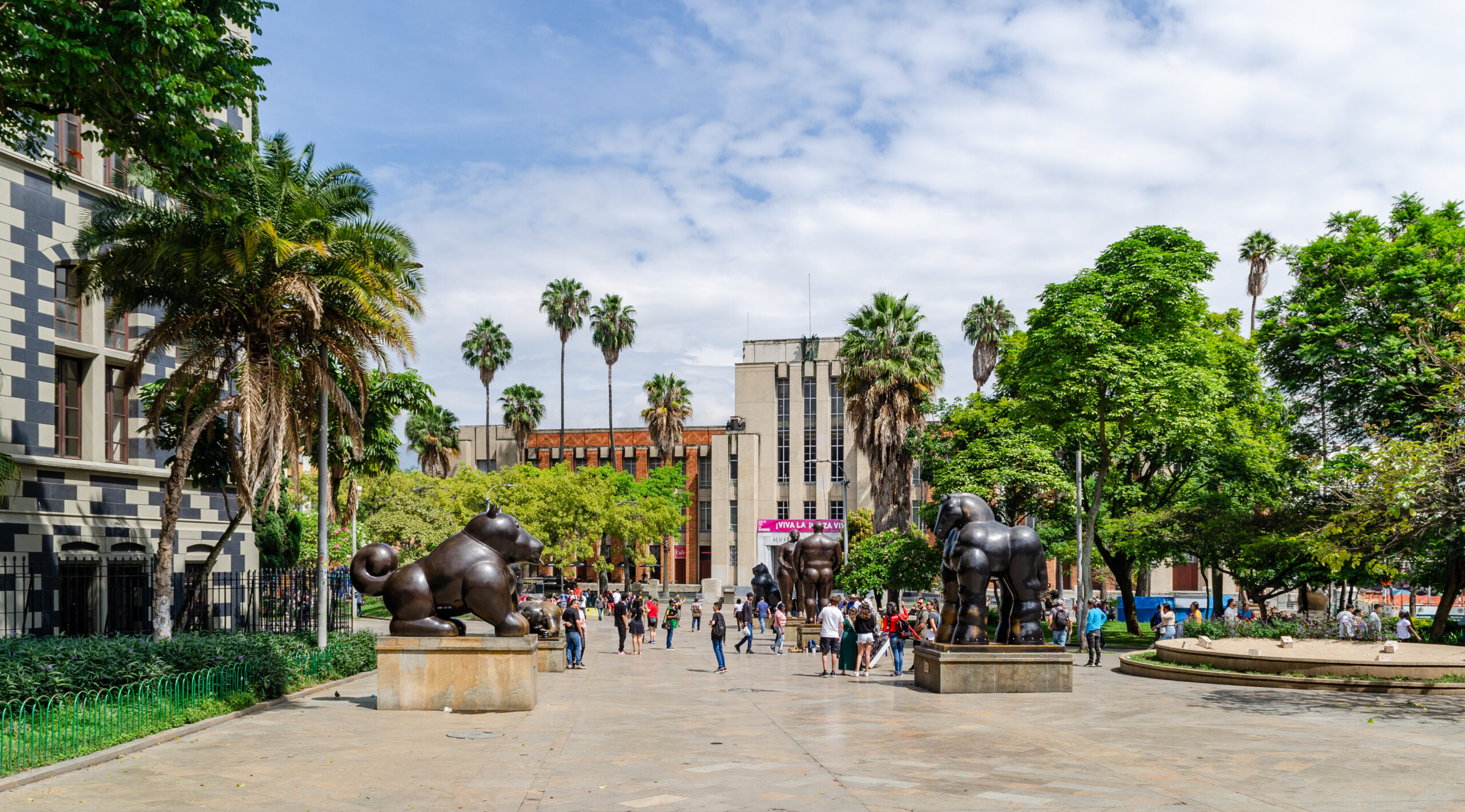 Street-level view of Plaza Botero in central Medellín with public art and pedestrians.