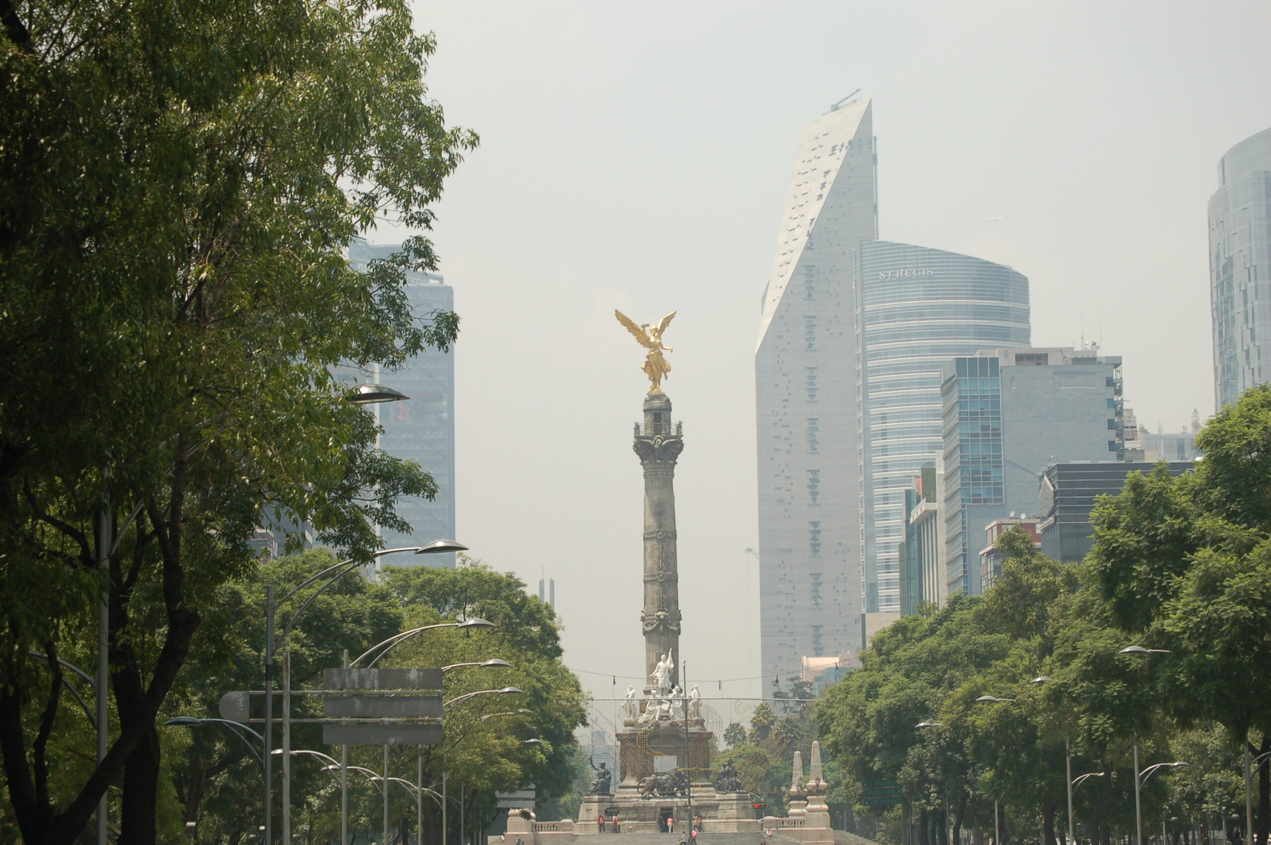 Ángel de la Independencia on Paseo de la Reforma with surrounding towers in the background.