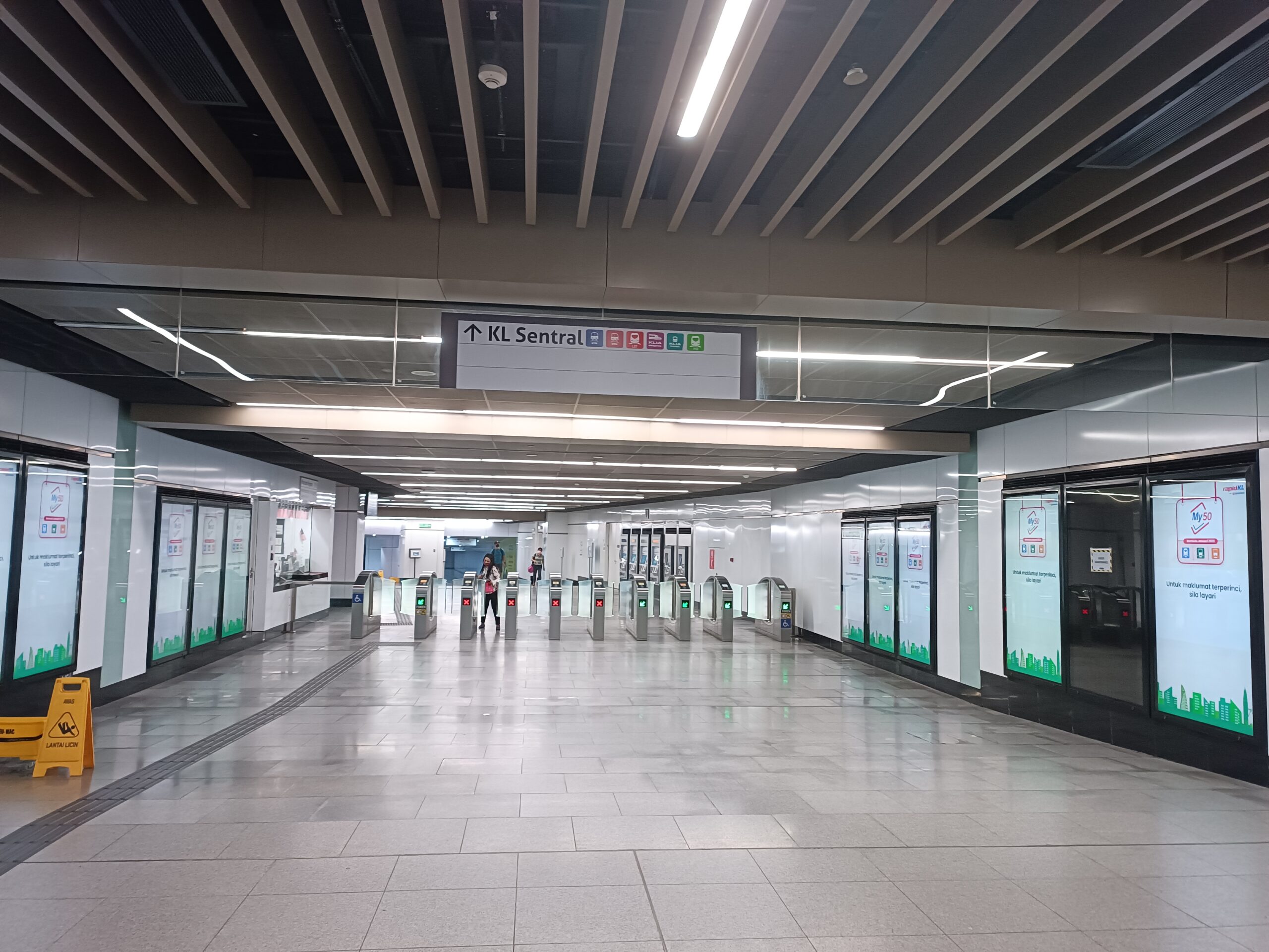 Covered walkway and escalator connection between Muzium Negara MRT Station and KL Sentral in Kuala Lumpur.