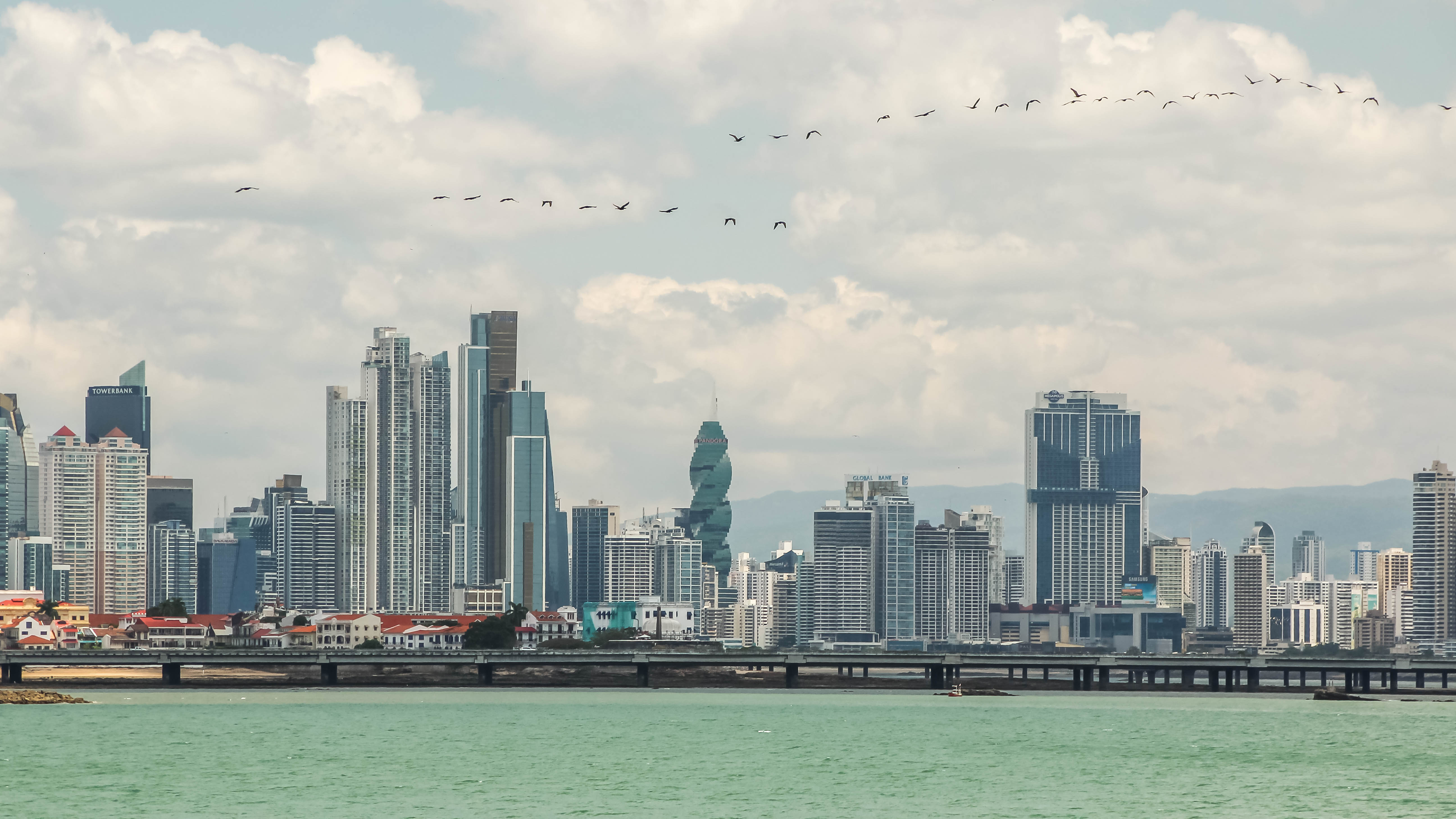 Panama skyline and waterfront view used to frame the tradeoff between warmth, convenience, and lower-intensity living.