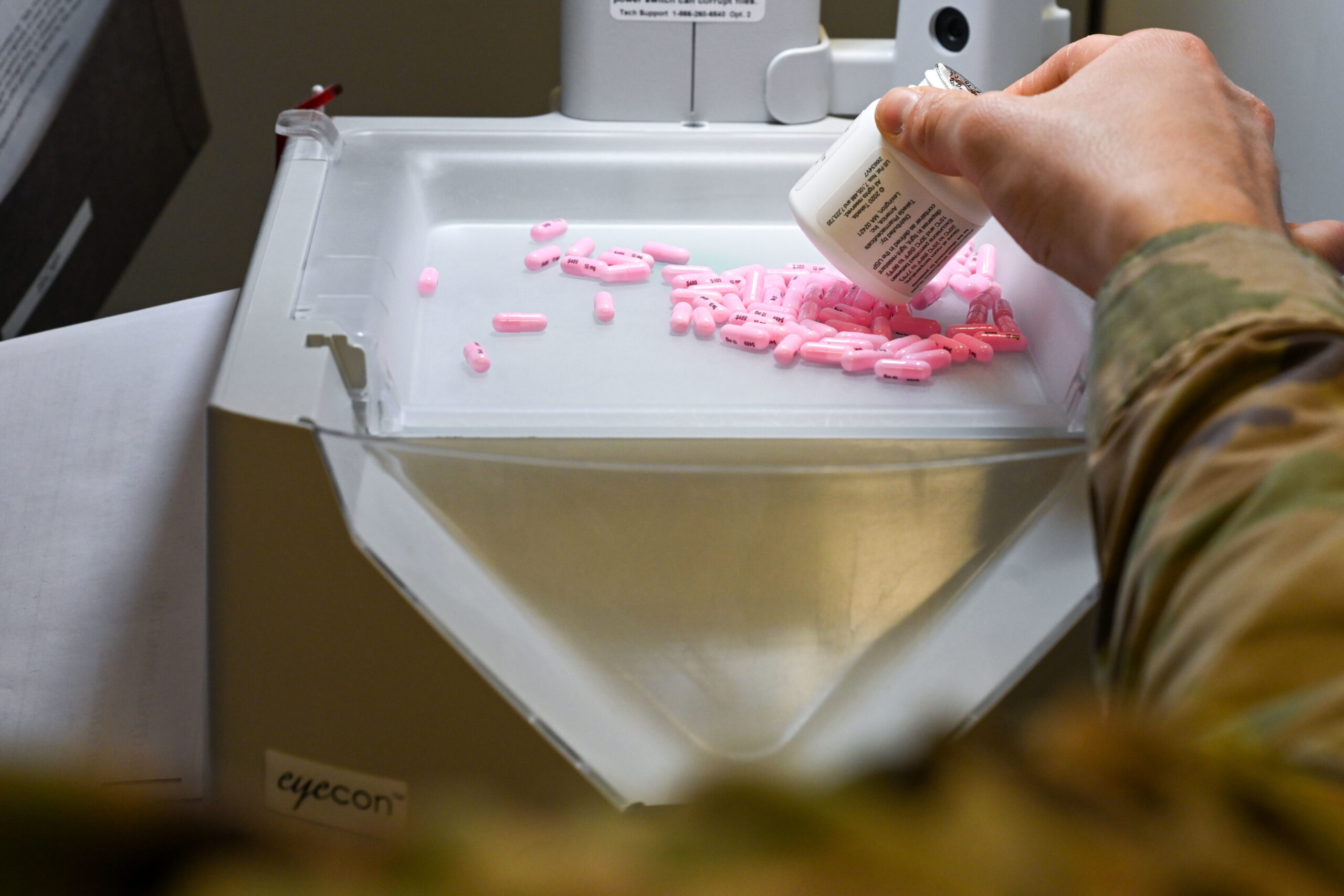 Pharmacy workflow with medication being processed in a licensed pharmacy setting