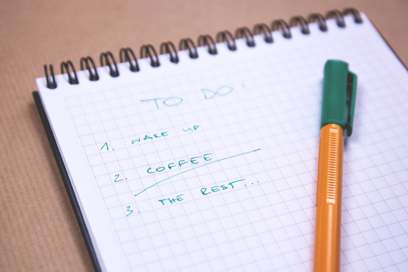 A handwritten checklist beside coffee for testing daily life before choosing a place abroad.