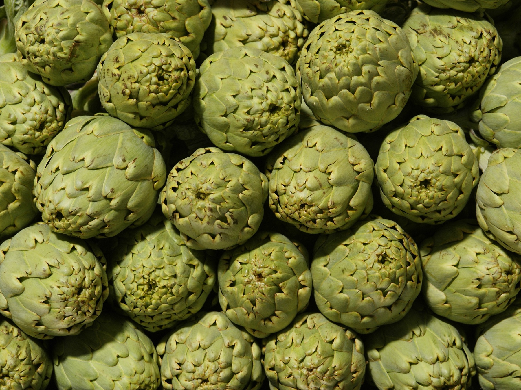 Fresh artichokes at a Valencia market, representing the grocery-based routine that helps keep a Spain budget realistic.