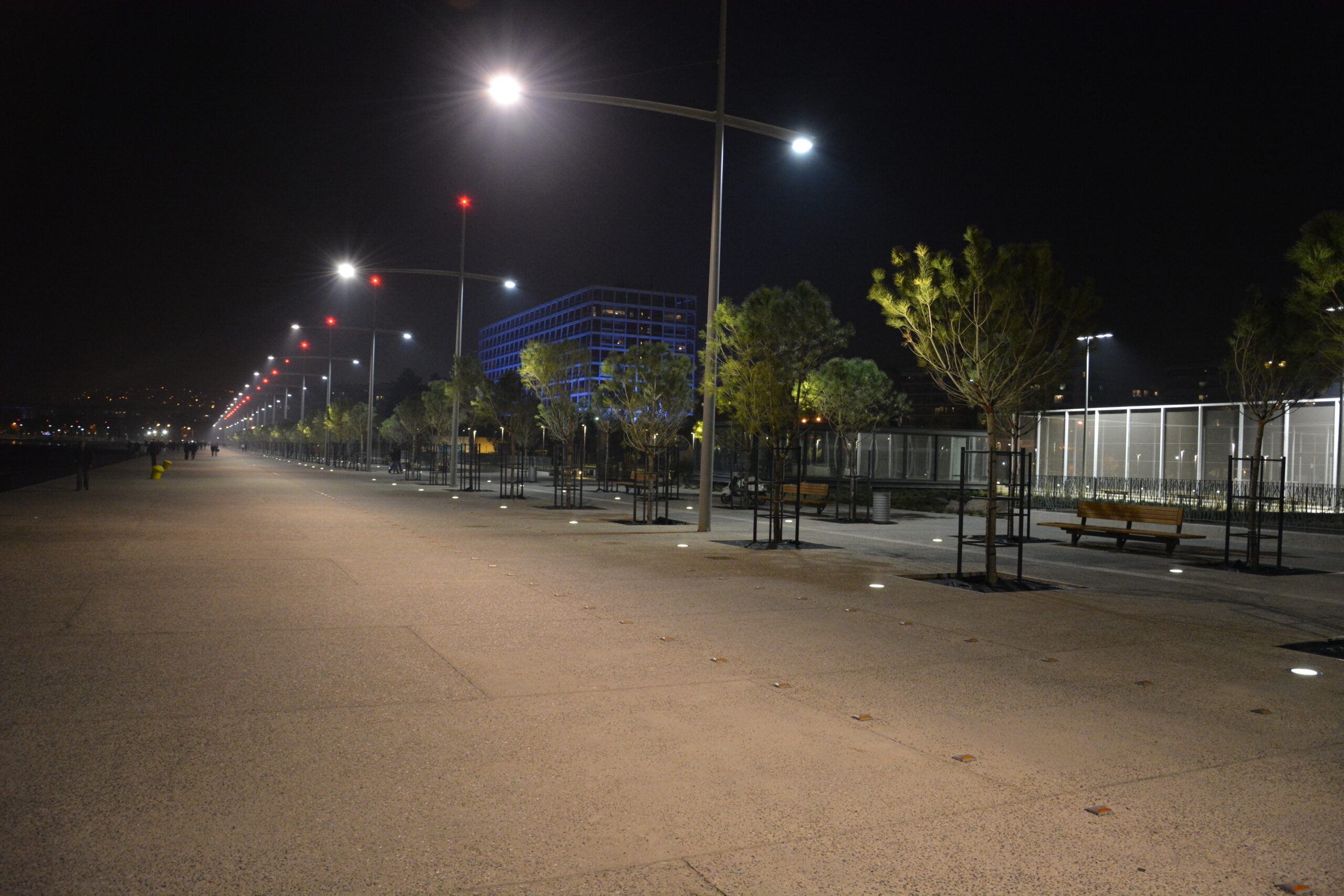 People walking along the Thessaloniki waterfront promenade, showing everyday city life and services near a longer-stay European base.