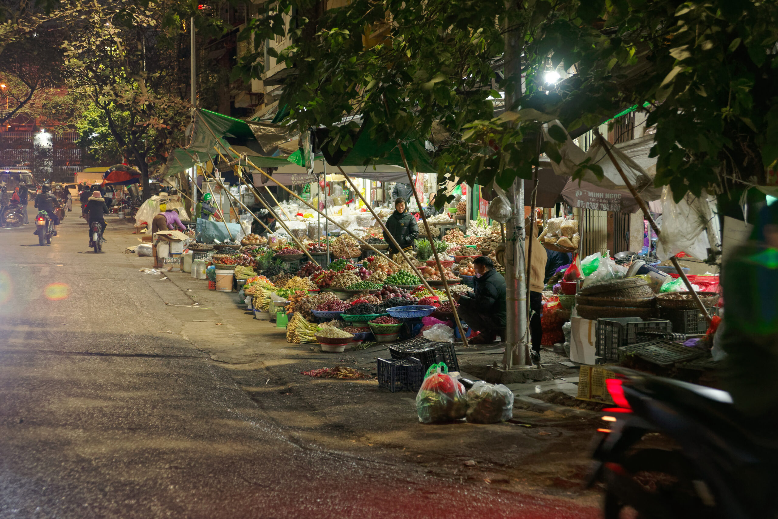 Market scene in Hanoi Old Quarter, showing the dense daily-life environment Americans should test before choosing Hanoi for a longer Vietnam stay.