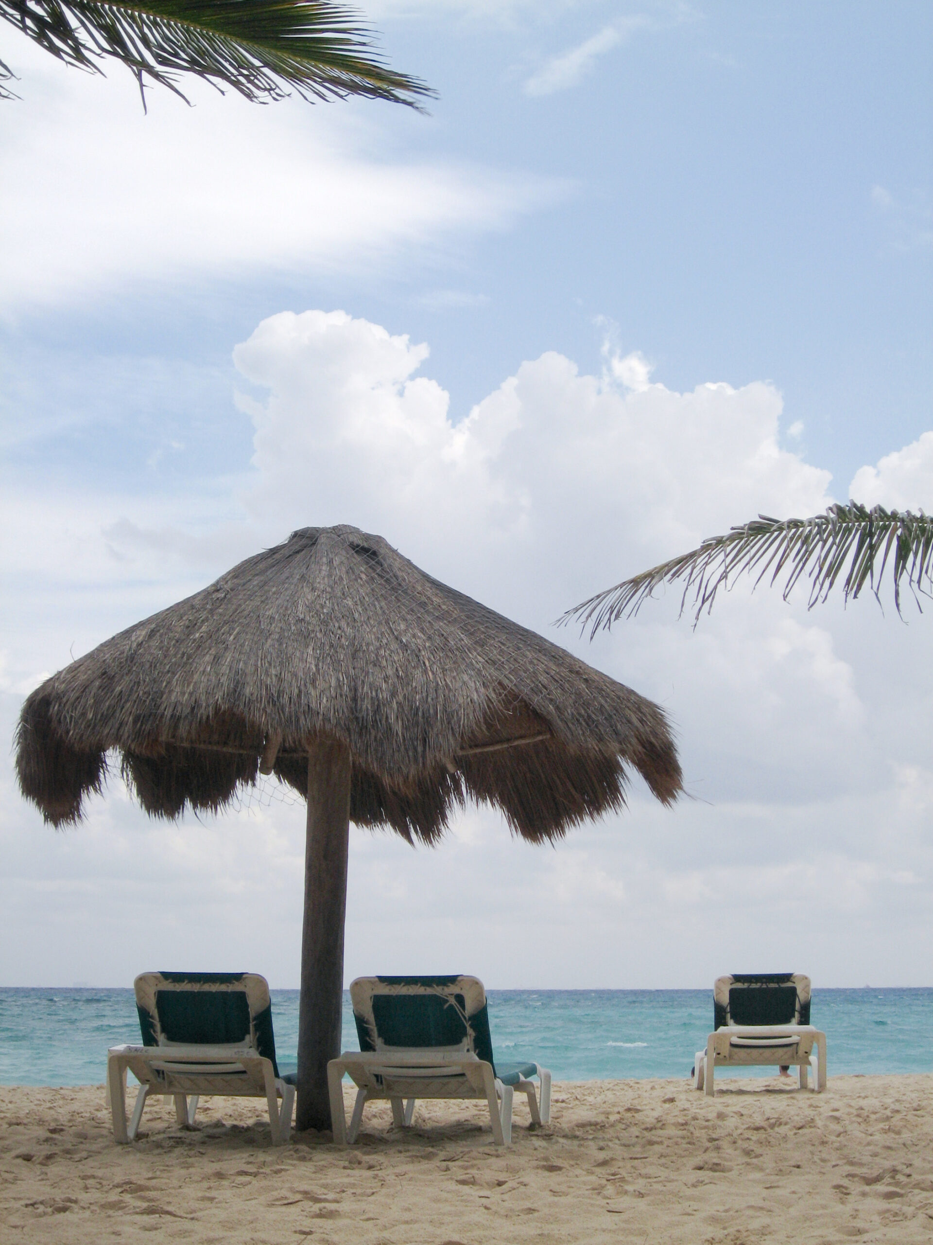 Beach chairs and a palapa on the beach in Playa del Carmen, Mexico.