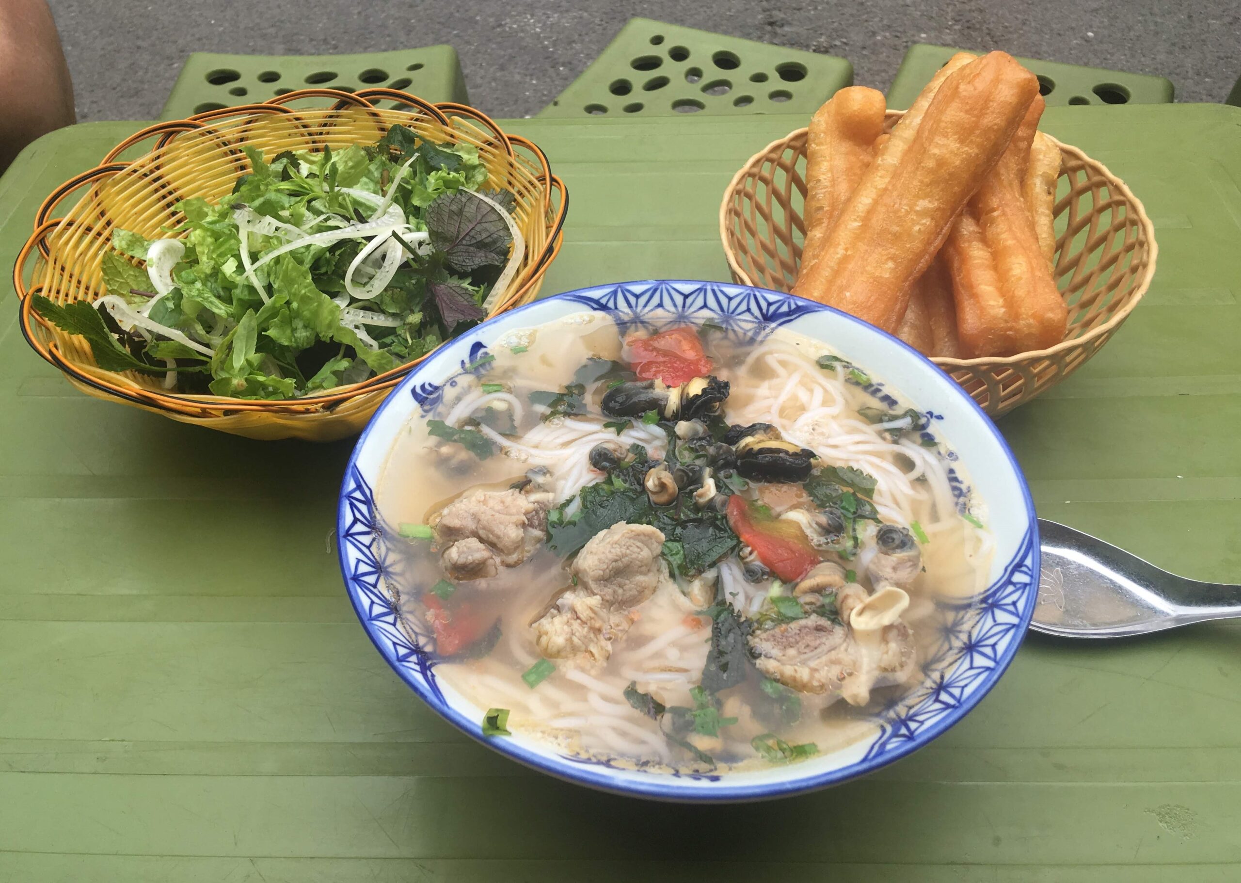 Street food in Hanoi, Vietnam, showing the everyday food routines that can keep a Hanoi monthly budget manageable.