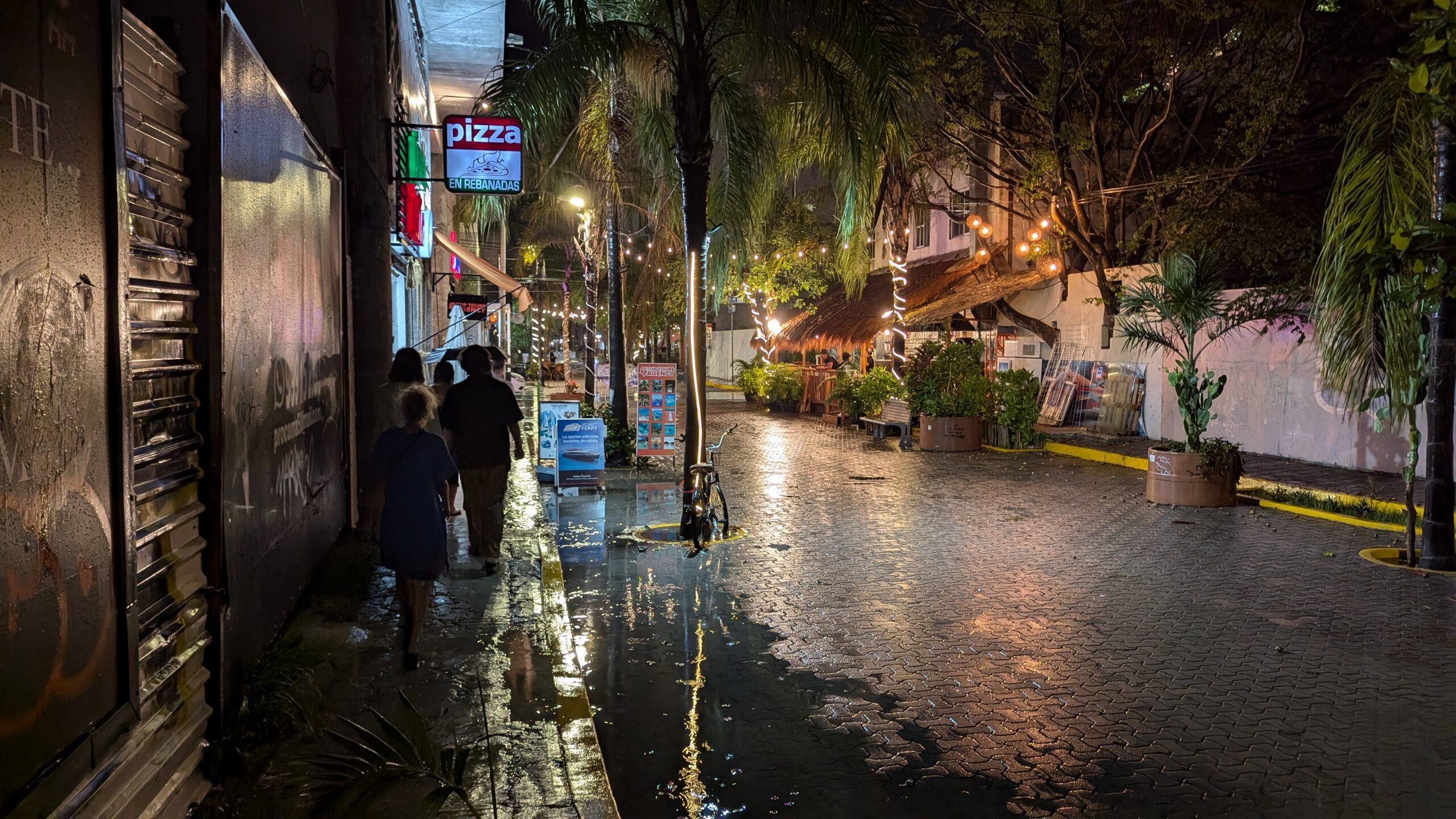 People walking along Avenida 5 in Playa del Carmen, Mexico.