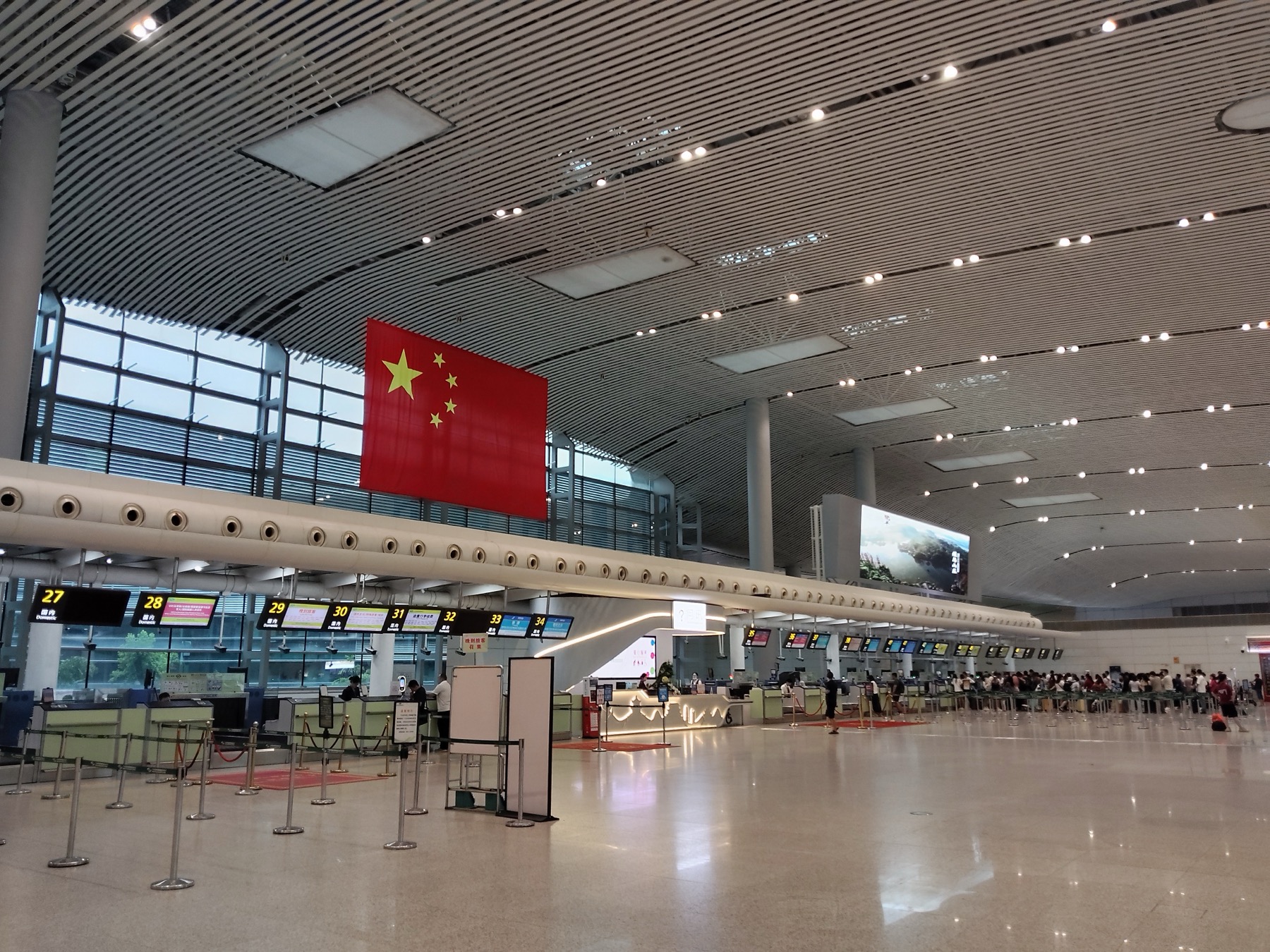 Airport service counters with luggage and passengers nearby.