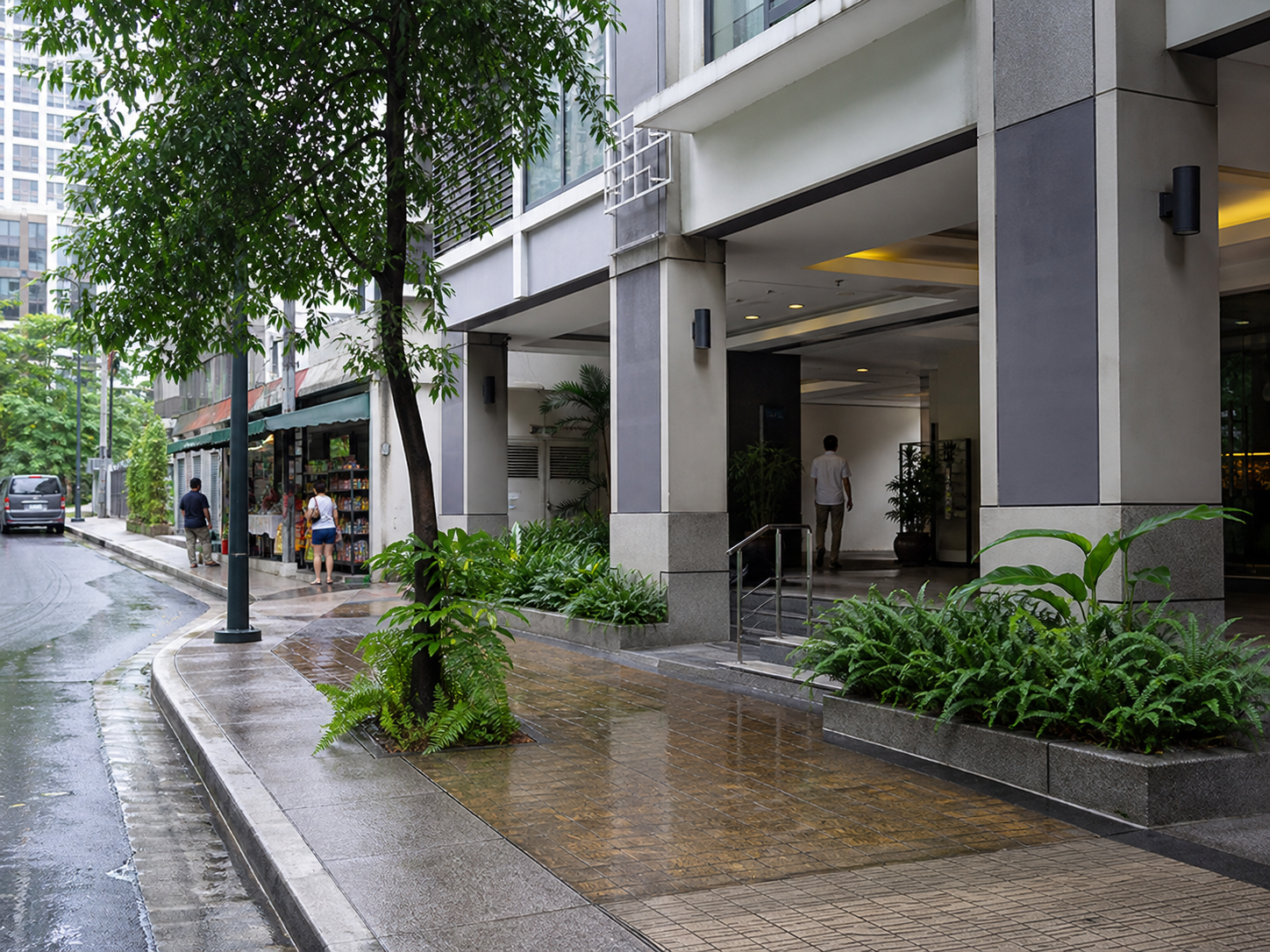 Illustrative modern Makati or BGC apartment entrance beside a rain-wet sidewalk and a small everyday grocery route.