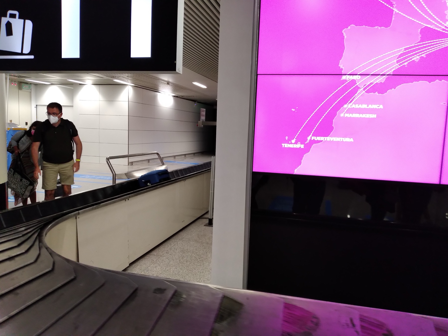 Checked luggage moving on an airport baggage carousel in Barcelona.