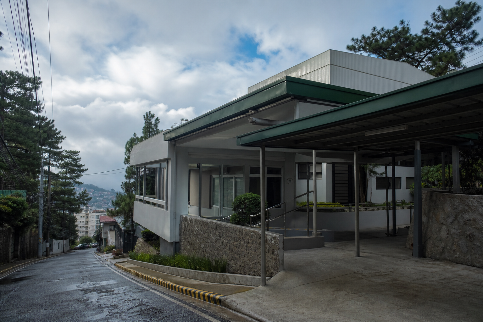 Illustrative covered healthcare drop-off and sloped street in Baguio.