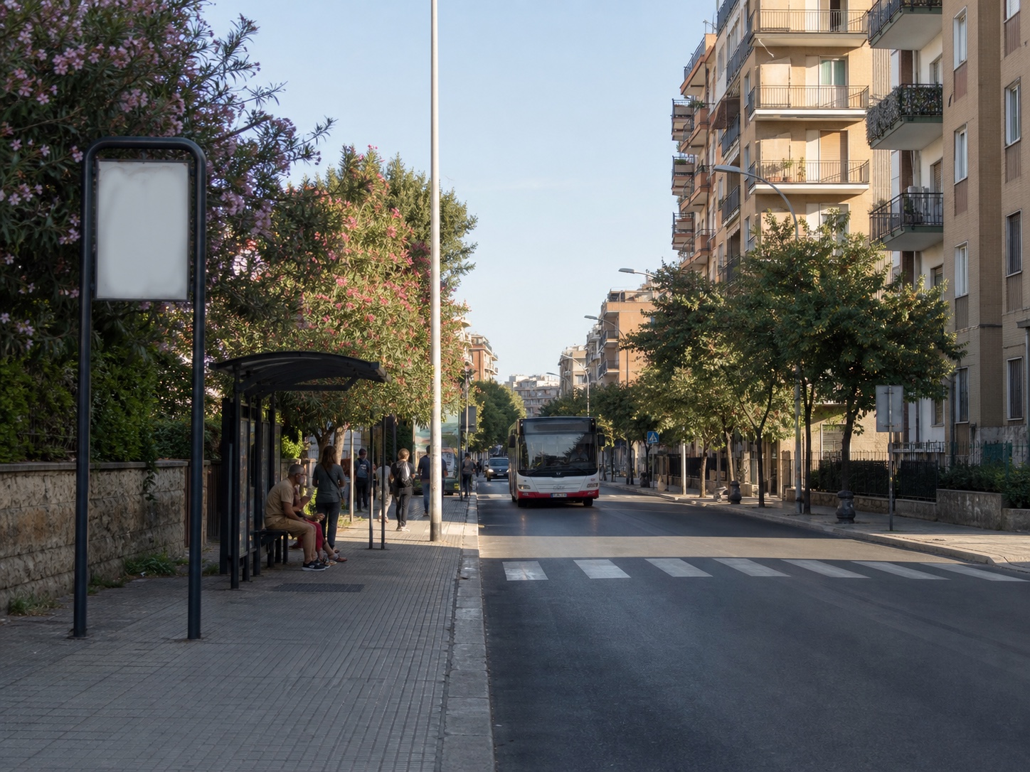 Bari city bus approaching a residential stop along a tree-lined street.
