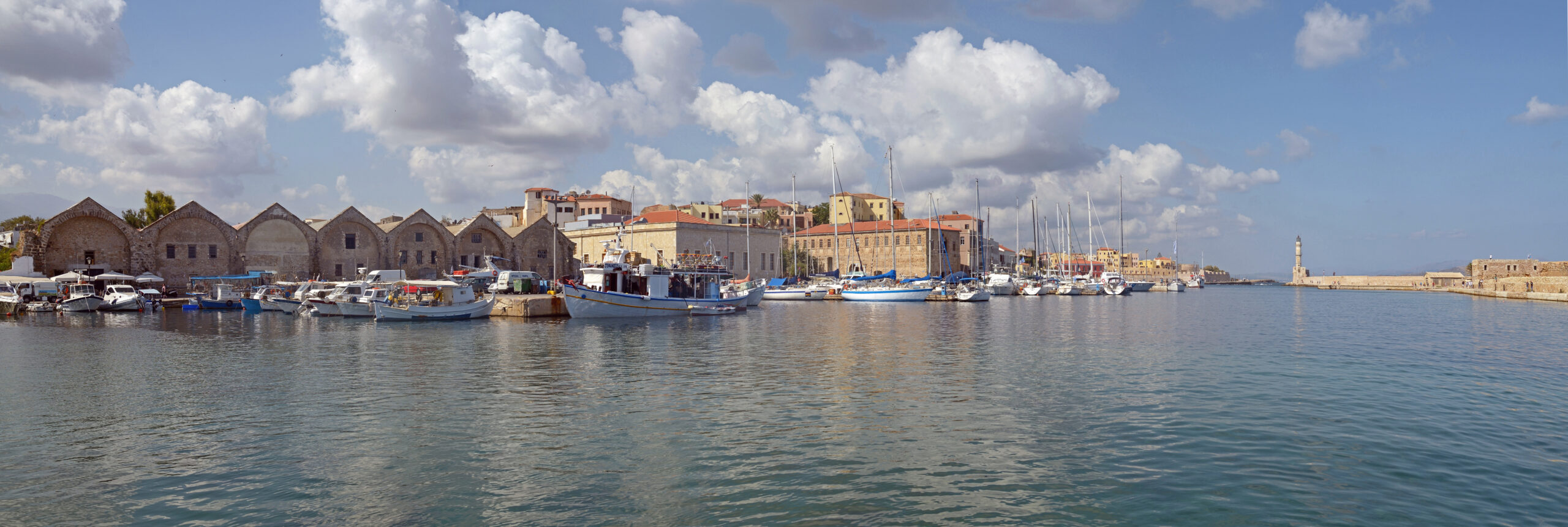 The harbor, Venetian shipyards, and lighthouse in Chania, Crete.