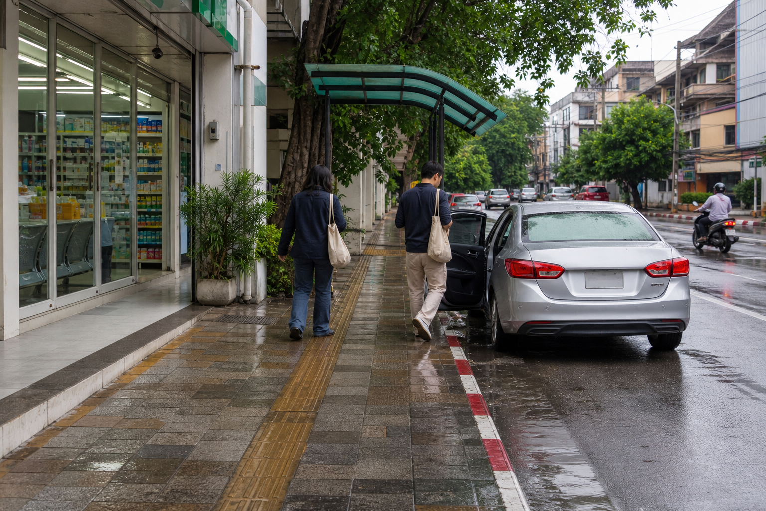 Chiang Mai sidewalk after rain with a pharmacy storefront, covered pickup area, people with tote bags, and a car at the curb.