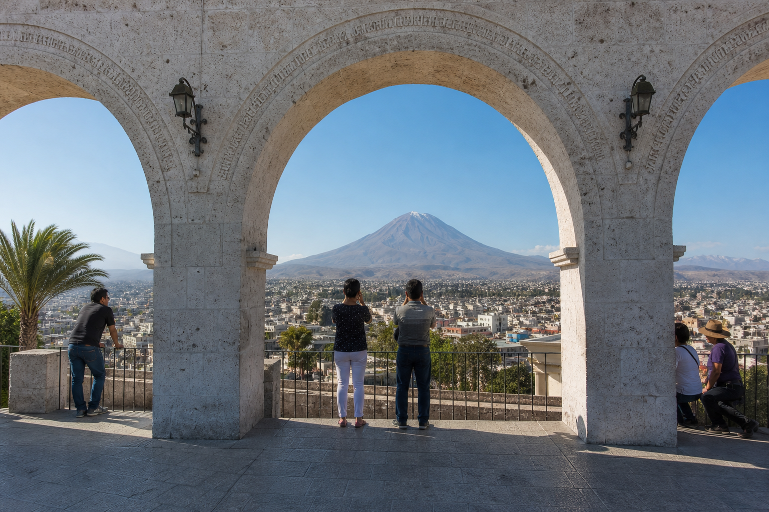 Misti volcano is framed by the pale stone arches of Yanahuara viewpoint above Arequipa.